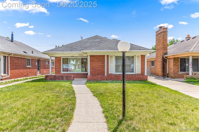 5944 Hubbell St, Dearborn Heights, MI 48127 - view of front of home with brick siding, a front yard, and covered porch