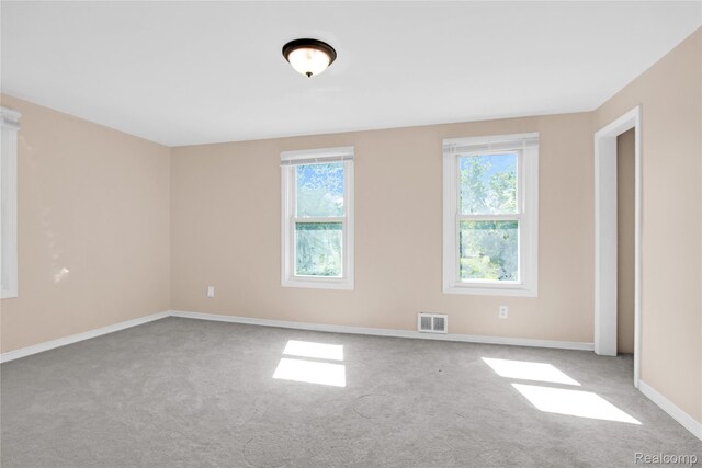 19186 Lamont St, Detroit, MI 48234 - empty room with carpet flooring and plenty of natural light