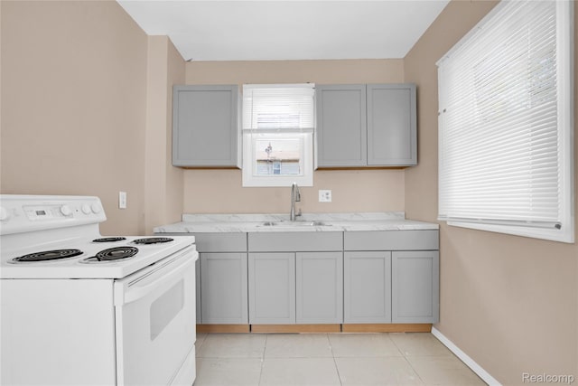 19186 Lamont St, Detroit, MI 48234 - kitchen featuring electric range, gray cabinetry, light tile patterned floors, and light countertops