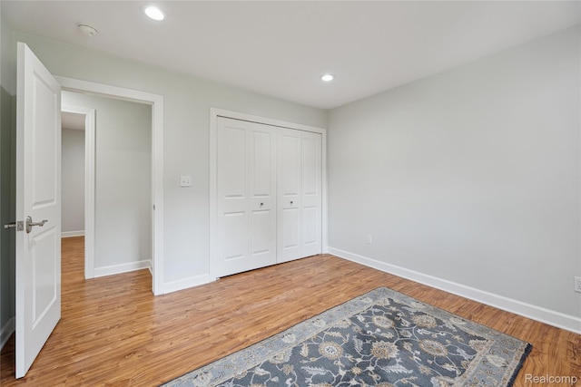 3395 W Maple Rd, Wixom, MI 48393 - unfurnished bedroom with light wood-style floors, recessed lighting, and a closet