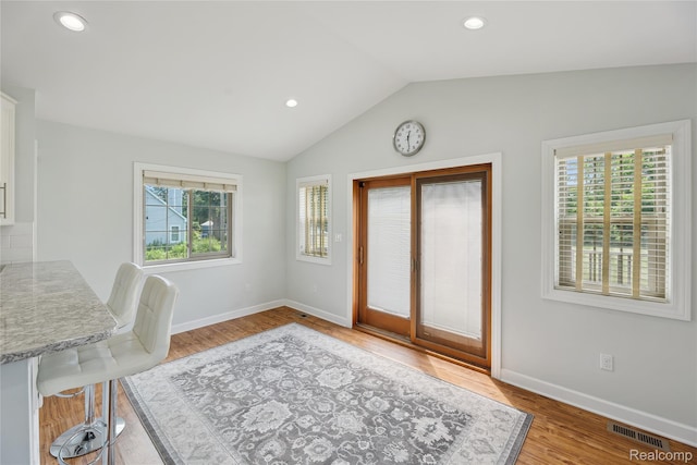 3395 W Maple Rd, Wixom, MI 48393 - foyer entrance featuring plenty of natural light, wood finished floors, vaulted ceiling, and recessed lighting