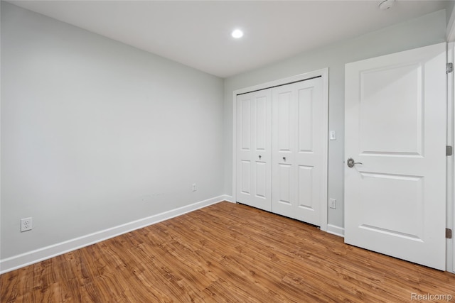 3395 W Maple Rd, Wixom, MI 48393 - unfurnished bedroom with light wood-type flooring, recessed lighting, and a closet