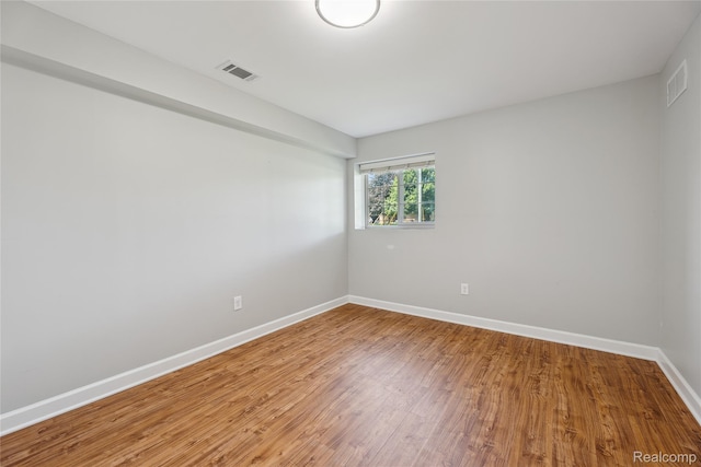 3395 W Maple Rd, Wixom, MI 48393 - empty room with wood finished floors and baseboards