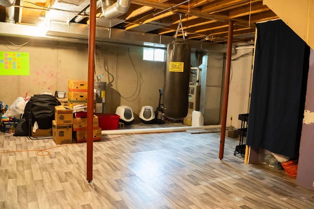 181 Spring St, Hillsdale, MI 49242 - below grade area with wood finished floors and water heater