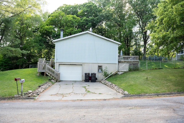181 Spring St, Hillsdale, MI 49242 - view of side of property with a wooden deck, concrete driveway, view of scattered trees, stairs, and a garage