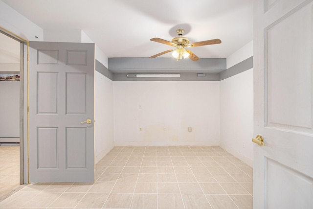 11303 W Dr N, Bellevue, MI 49021 - spare room featuring a ceiling fan and a baseboard radiator