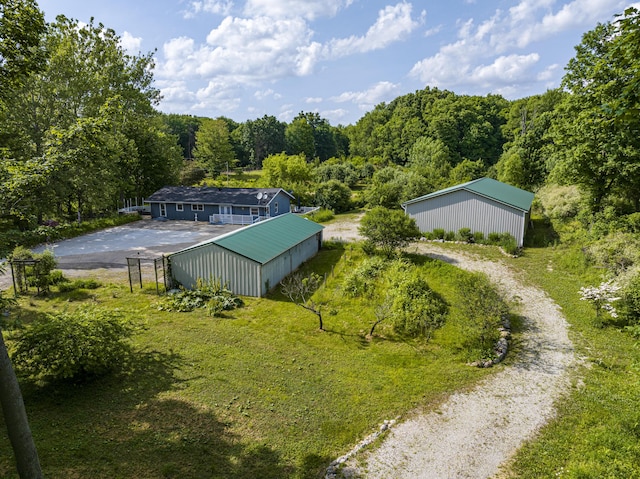 11303 W Dr N, Bellevue, MI 49021 - aerial view of property and surrounding area featuring a heavily wooded area