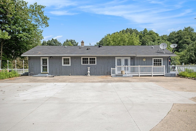 11303 W Dr N, Bellevue, MI 49021 - rear view of house with a patio, french doors, and a chimney