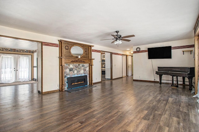 11303 W Dr N, Bellevue, MI 49021 - unfurnished living room with a ceiling fan, dark wood finished floors, and a large fireplace