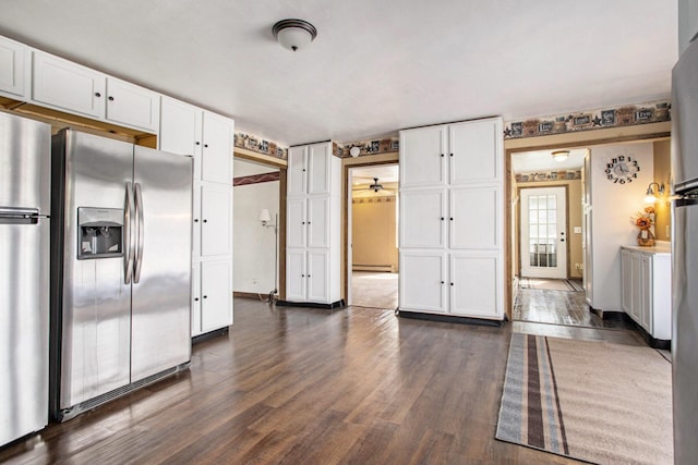 11303 W Dr N, Bellevue, MI 49021 - kitchen with stainless steel fridge, white cabinetry, freestanding refrigerator, and dark wood-style floors