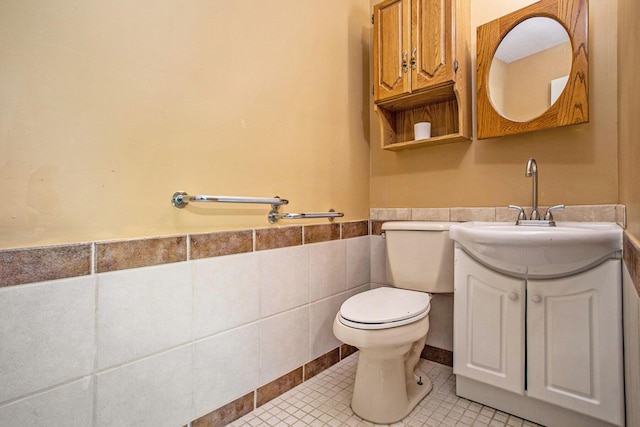 11303 W Dr N, Bellevue, MI 49021 - bathroom with tile walls, vanity, a wainscoted wall, and tile patterned flooring