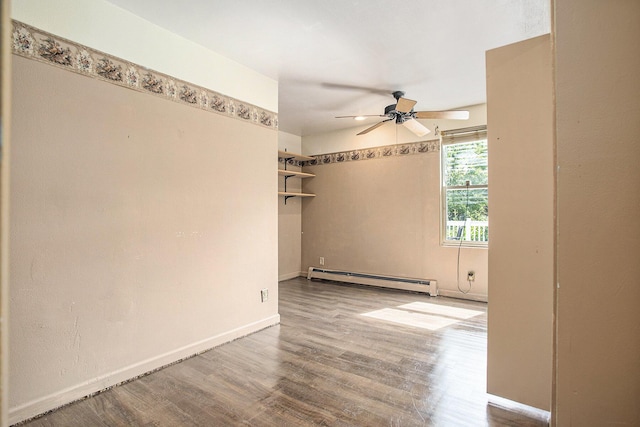 11303 W Dr N, Bellevue, MI 49021 - spare room with a baseboard heating unit, a ceiling fan, and wood finished floors