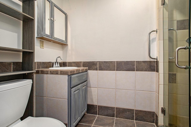 11303 W Dr N, Bellevue, MI 49021 - bathroom featuring tile walls, vanity, a shower stall, and wainscoting