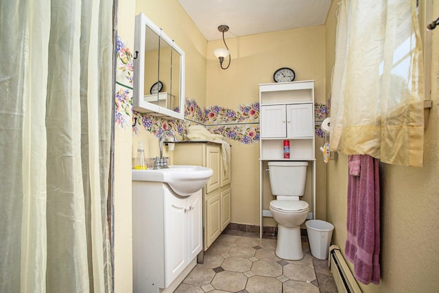 11303 W Dr N, Bellevue, MI 49021 - full bath with a baseboard heating unit, vanity, and tile patterned floors
