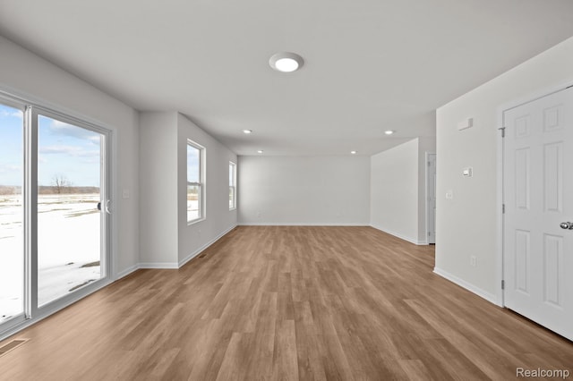 48495 Old Oak Trl, Van Buren, MI 48111 - unfurnished living room featuring light wood-style floors and recessed lighting