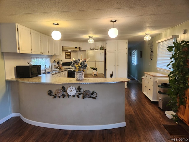 626 Barefoot Ln, Port Sanilac, MI 48469 - kitchen featuring white appliances, a peninsula, white cabinetry, under cabinet range hood, and pendant lighting