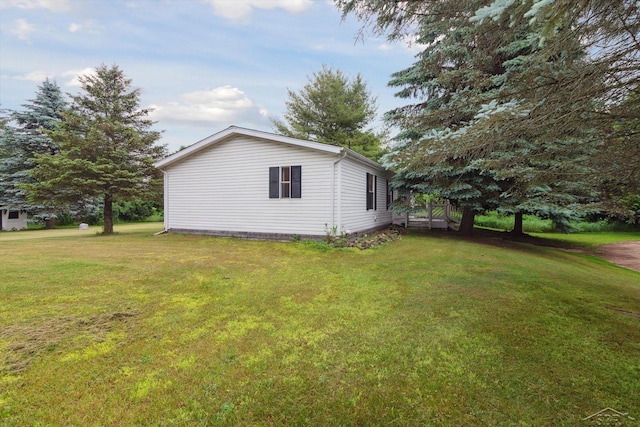 4150 Buzzell Rd, Gladwin, MI 48624 - view of side of property featuring a lawn