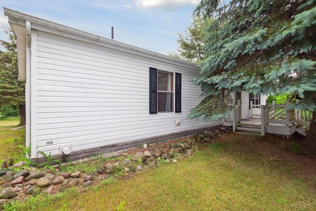 4150 Buzzell Rd, Gladwin, MI 48624 - view of property exterior featuring a wooden deck and a yard