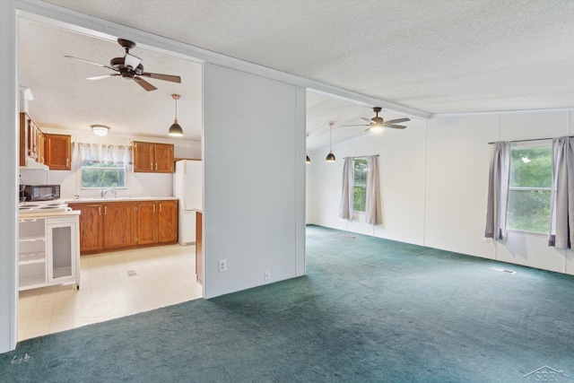 4150 Buzzell Rd, Gladwin, MI 48624 - unfurnished living room featuring ceiling fan, a textured ceiling, and light colored carpet