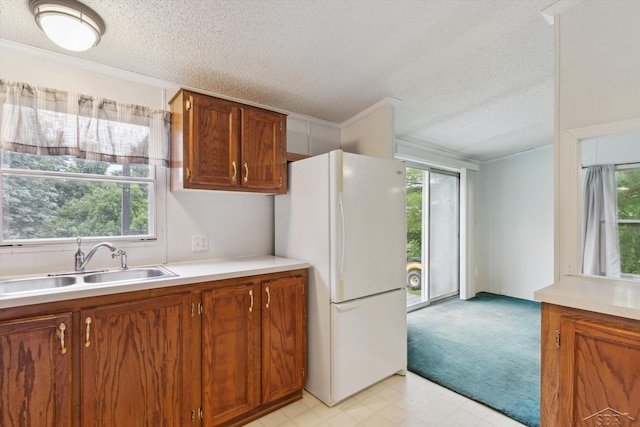 4150 Buzzell Rd, Gladwin, MI 48624 - kitchen featuring freestanding refrigerator, a textured ceiling, light countertops, light carpet, and light floors
