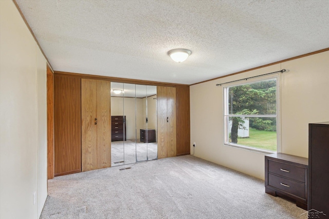 4150 Buzzell Rd, Gladwin, MI 48624 - unfurnished bedroom featuring carpet floors, a closet, ornamental molding, and a textured ceiling