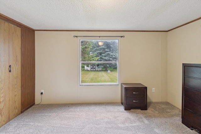 4150 Buzzell Rd, Gladwin, MI 48624 - unfurnished bedroom featuring carpet, ornamental molding, and a textured ceiling