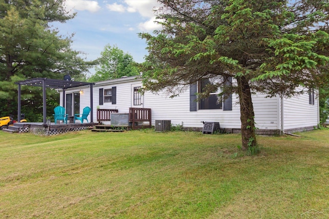 4150 Buzzell Rd, Gladwin, MI 48624 - back of property with a pergola, a wooden deck, and a lawn