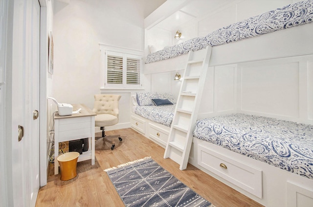 4449 Cordley Lake Rd, Pinckney, MI 48169 - bedroom featuring a decorative wall and light wood-style floors