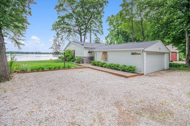 4449 Cordley Lake Rd, Pinckney, MI 48169 - view of front of home with a water view and a garage