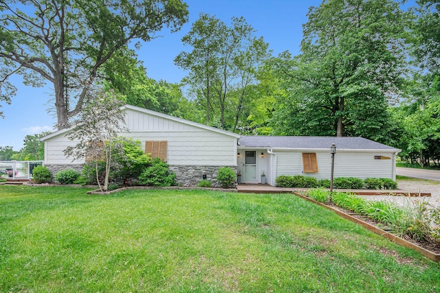 4449 Cordley Lake Rd, Pinckney, MI 48169 - view of front of home with stone siding and a front lawn
