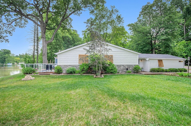 4449 Cordley Lake Rd, Pinckney, MI 48169 - view of grassy yard featuring a deck with water view and view of wooded area