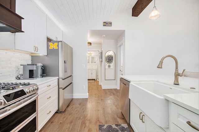 4449 Cordley Lake Rd, Pinckney, MI 48169 - kitchen with custom range hood, appliances with stainless steel finishes, light wood-type flooring, white cabinetry, and light countertops