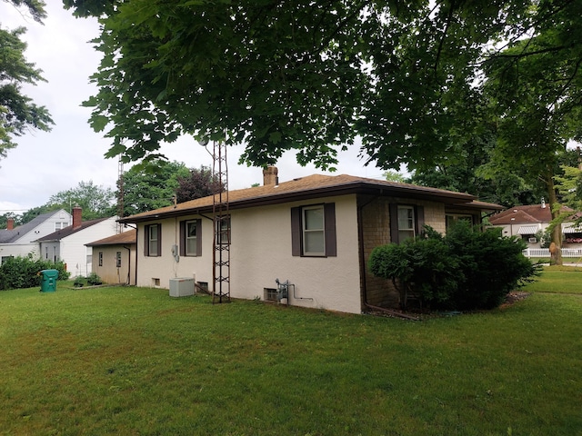 420 N 14th St, Niles, MI 49120 - view of front of house with a chimney, a front yard, and stucco siding