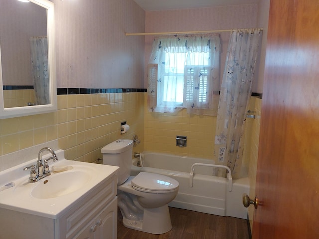 420 N 14th St, Niles, MI 49120 - full bathroom with shower / tub combo, vanity, wood finished floors, tile walls, and a wainscoted wall