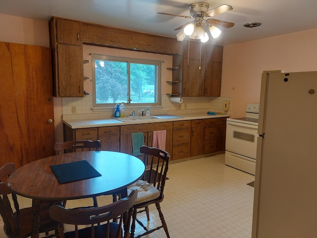 420 N 14th St, Niles, MI 49120 - kitchen featuring white appliances, light floors, brown cabinets, and tasteful backsplash