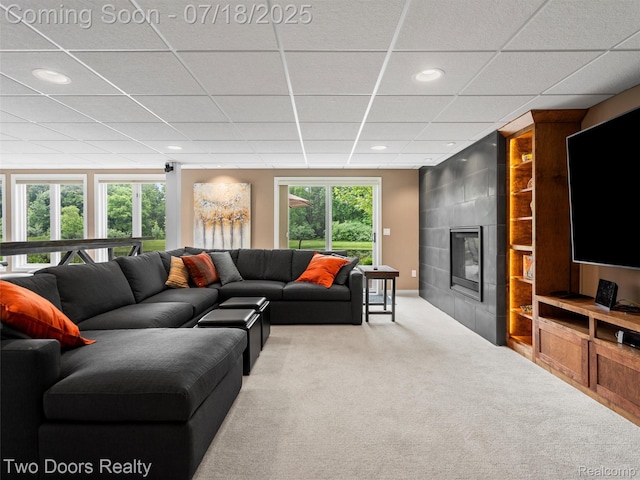 3551 Royal Berkshire Ln, Oakland, MI 48363 - carpeted living room featuring a drop ceiling, a tiled fireplace, and recessed lighting