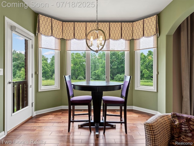 3551 Royal Berkshire Ln, Oakland, MI 48363 - dining space featuring a chandelier and wood finished floors