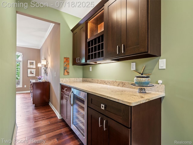 3551 Royal Berkshire Ln, Oakland, MI 48363 - kitchen featuring wine cooler, dark wood finished floors, dark brown cabinetry, crown molding, and light stone countertops