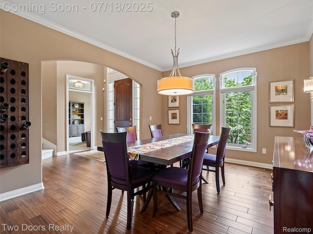 3551 Royal Berkshire Ln, Oakland, MI 48363 - dining room featuring arched walkways, crown molding, and wood finished floors