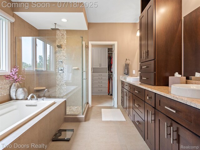3551 Royal Berkshire Ln, Oakland, MI 48363 - bathroom featuring a shower stall, double vanity, a bath, tile patterned flooring, and a walk in closet