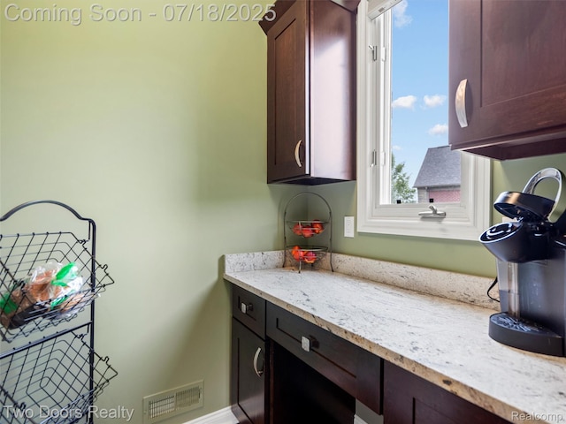 3551 Royal Berkshire Ln, Oakland, MI 48363 - kitchen featuring light stone countertops and dark brown cabinetry
