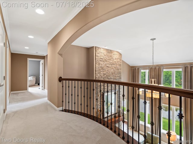 3551 Royal Berkshire Ln, Oakland, MI 48363 - hallway with carpet floors, arched walkways, crown molding, recessed lighting, and an upstairs landing