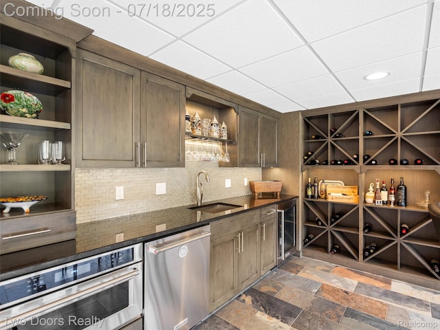 3551 Royal Berkshire Ln, Oakland, MI 48363 - kitchen featuring open shelves, appliances with stainless steel finishes, backsplash, beverage cooler, and dark stone counters