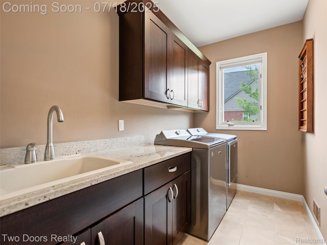 3551 Royal Berkshire Ln, Oakland, MI 48363 - laundry area with cabinet space, washing machine and dryer, and light tile patterned floors