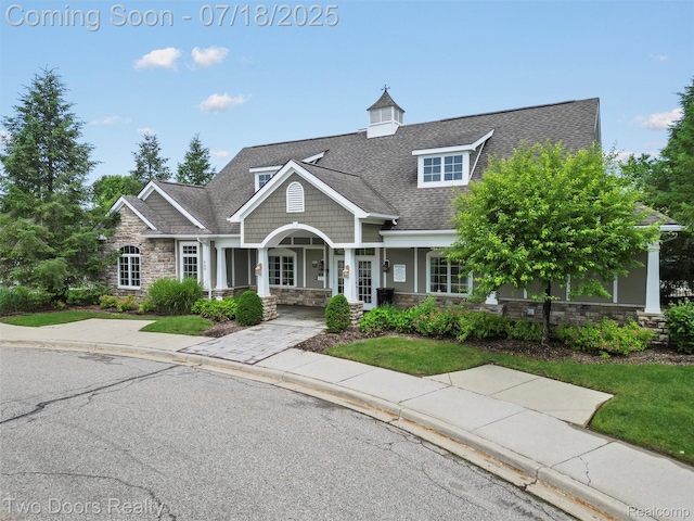 3551 Royal Berkshire Ln, Oakland, MI 48363 - craftsman inspired home with stone siding, roof with shingles, and a porch