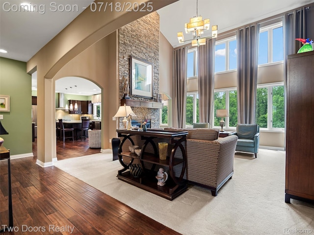 3551 Royal Berkshire Ln, Oakland, MI 48363 - living room with arched walkways, a high ceiling, wood finished floors, and recessed lighting
