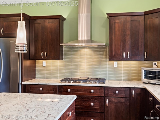 3551 Royal Berkshire Ln, Oakland, MI 48363 - kitchen with wall chimney range hood, tasteful backsplash, dark brown cabinetry, and appliances with stainless steel finishes