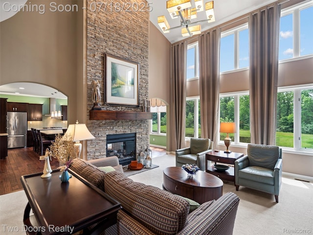 3551 Royal Berkshire Ln, Oakland, MI 48363 - living room with a towering ceiling, a fireplace, healthy amount of natural light, arched walkways, and a chandelier