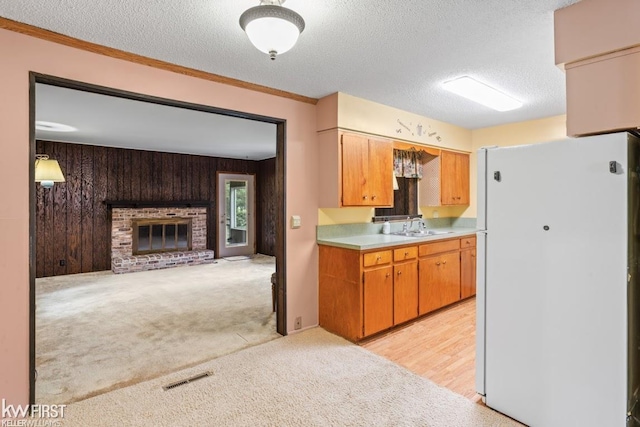 5232 Maple Ave, Swartz Creek, MI 48473 - kitchen featuring freestanding refrigerator, light countertops, light colored carpet, a textured ceiling, and open floor plan