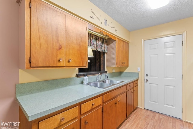5232 Maple Ave, Swartz Creek, MI 48473 - kitchen featuring light wood-style floors, a textured ceiling, light countertops, and brown cabinets